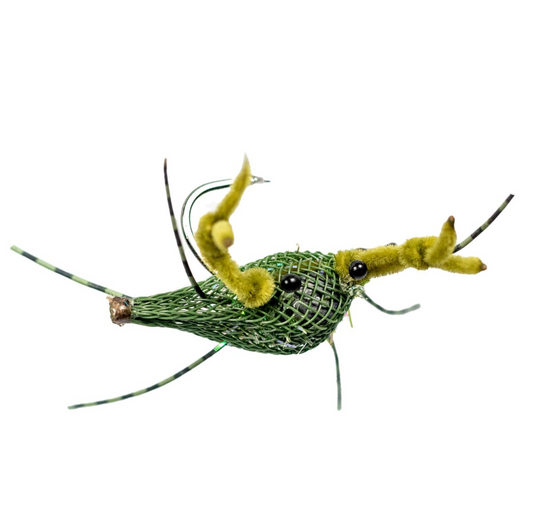 A handcrafted fishnet crab fly used for saltwater fishing, featuring a green body with yellow accents and flexible rubber legs.