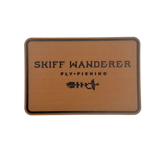 Brown hook pad with 'Skiff Wanderer Fly Fishing' text and logo. Perfect for redfish flies