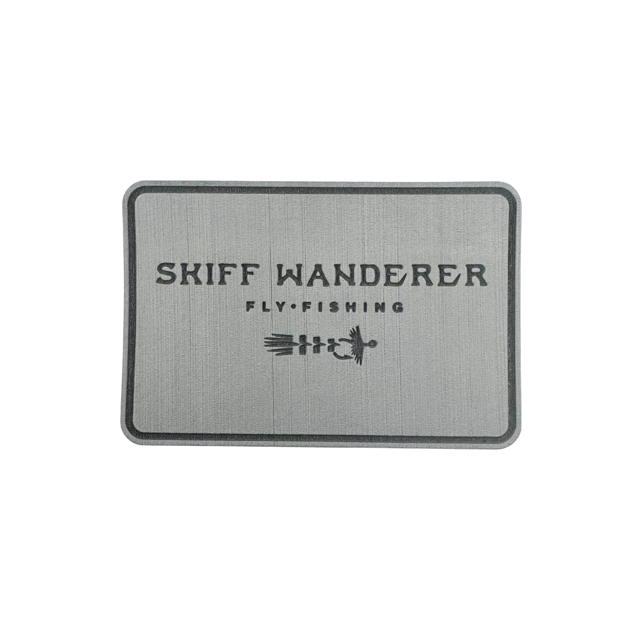 Rectangular gray fly pad with 'Skiff Wanderer Fly Fishing' text and logo on a white background. Perfect for redfish flies