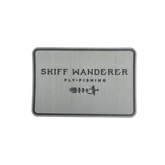 Rectangular gray fly pad with 'Skiff Wanderer Fly Fishing' text and logo on a white background. Perfect for redfish flies