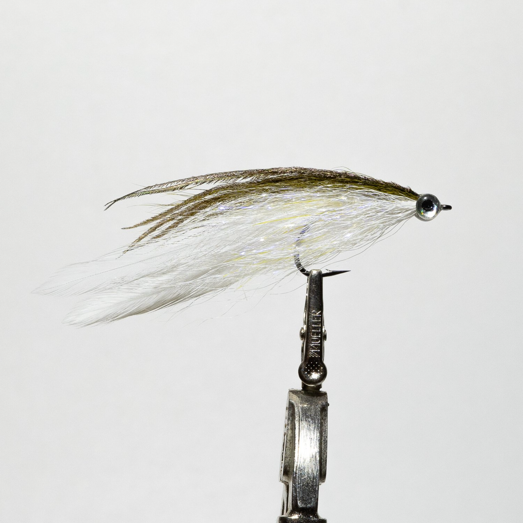 powerhouse fly tied with white and olive colors on a single hook for saltwater fly fishing